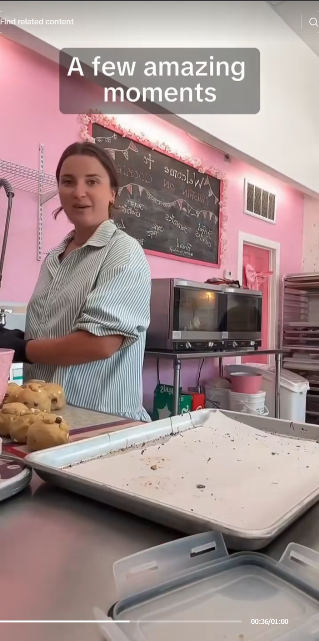 A woman in a light blue striped shirt stands behind a counter in a pink bakery or kitchen setting, with a large metal baking pan in the foreground and the text 'A few amazing moments' overlaid at the top.