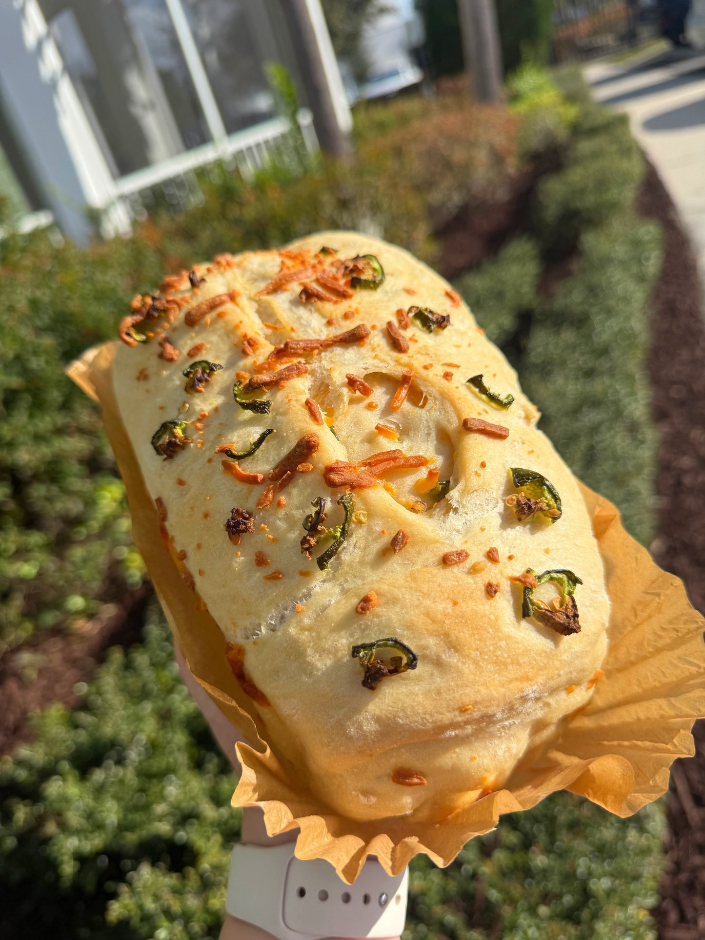 Handmade jalapeno cheddar artisan bread loaf with melted cheese and jalapeno pieces visible from Crushin on Cookies Plant City Florida